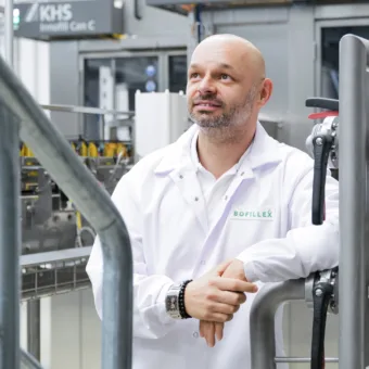 You can see Tomáš Zahálka, Managing Director at BOFILLEX, leaning on a machine.