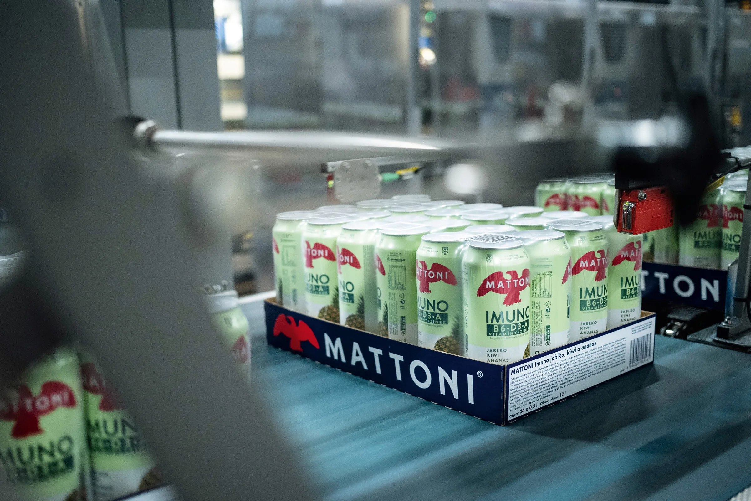 a pallet of cans on a conveyor belt